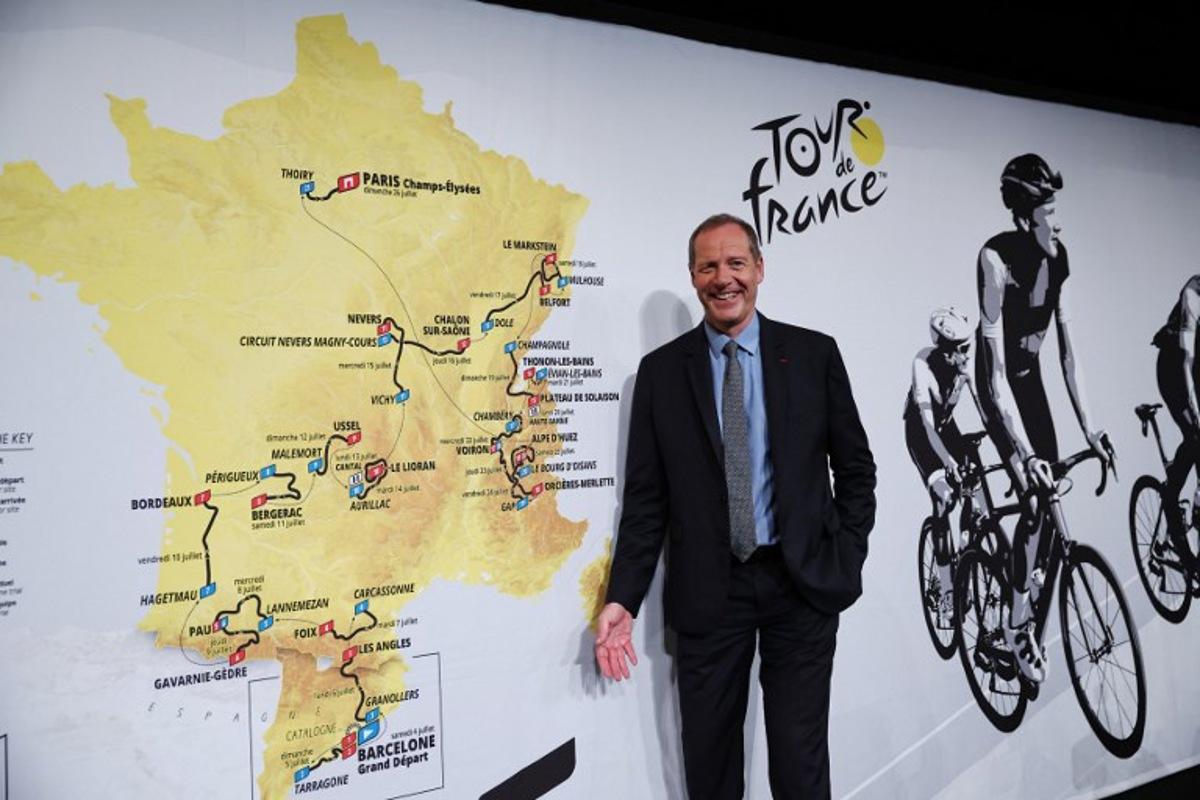 Tour de France General Director Christian Prudhomme poses for a picture in front of the map showing the women's route during the presentation of the official routes of the 2026 edition of the men's and women's Tour de France cycling race in Paris on October 23, 2025. Anne-Christine POUJOULAT / AFP