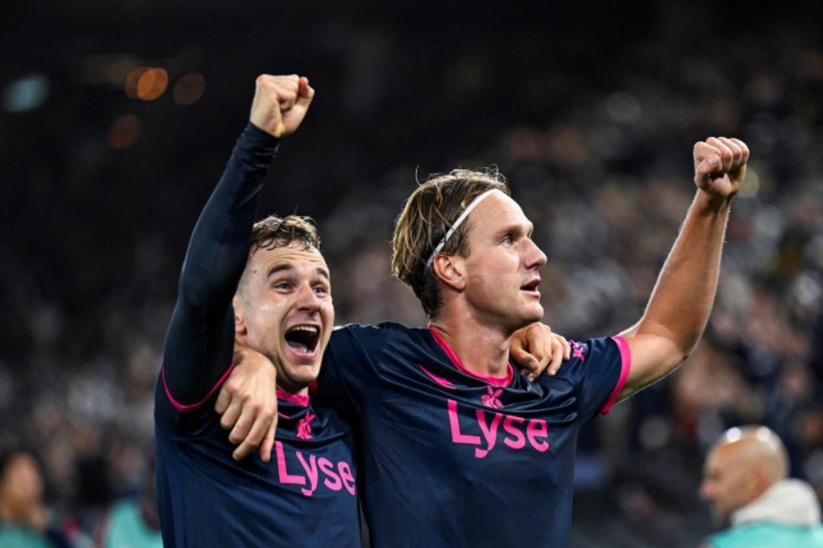 Viking's Danish forward #20 Peter Buch Christiansen (L) celebrates scoring his team's second goal during the UEFA Champions League football match between Viking FK and FC Bayern Munich in Stavanger, Norway on October 13, 2026. Carina Johansen / NTB / AFP