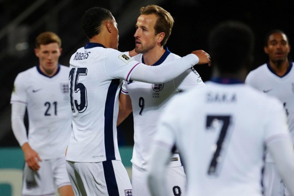 England's forward #09 Harry Kane celebrates scoring the 0-2 goal with his teammates including England forward #15 Morgan Rogers during the 2026 World Cup qualifying group K football match between Latvia and England at the Daugava Stadium in Riga, Latvia on October 14, 2025, Gints Ivuskans / AFP