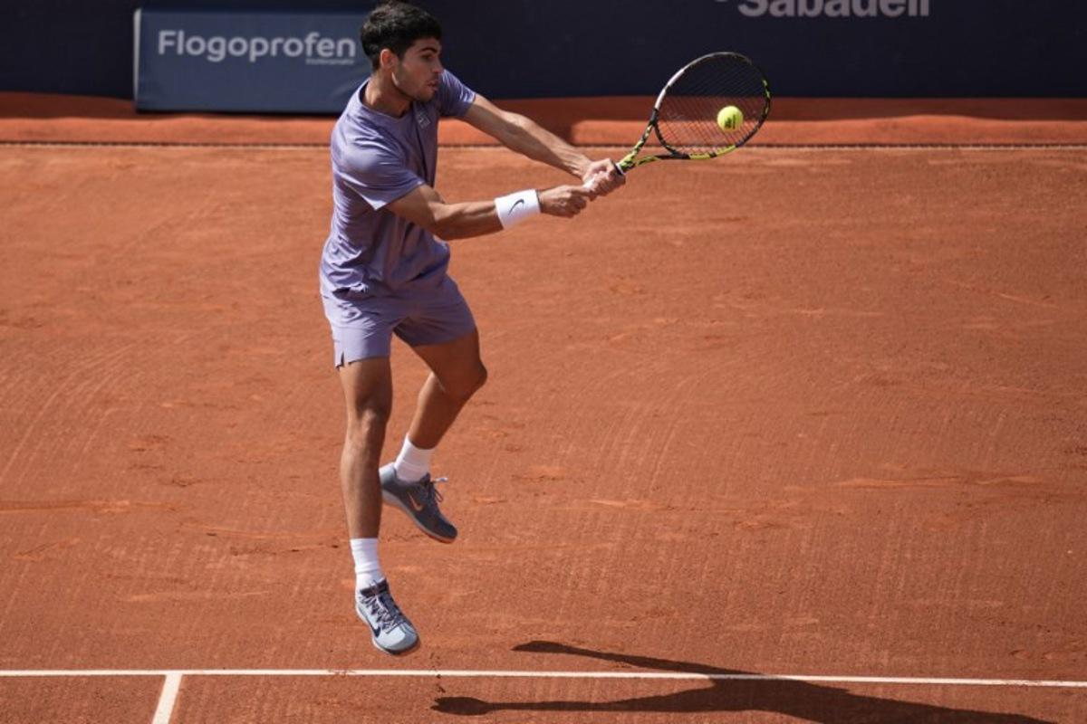Spain's Carlos Alcaraz returns the ball to France's Arthur Fils during the ATP Barcelona Open "Conde de Godo" tennis tournament singles semi-final match at the Real Club de Tenis in Barcelona, on April 19, 2025. MANAURE QUINTERO / AFP