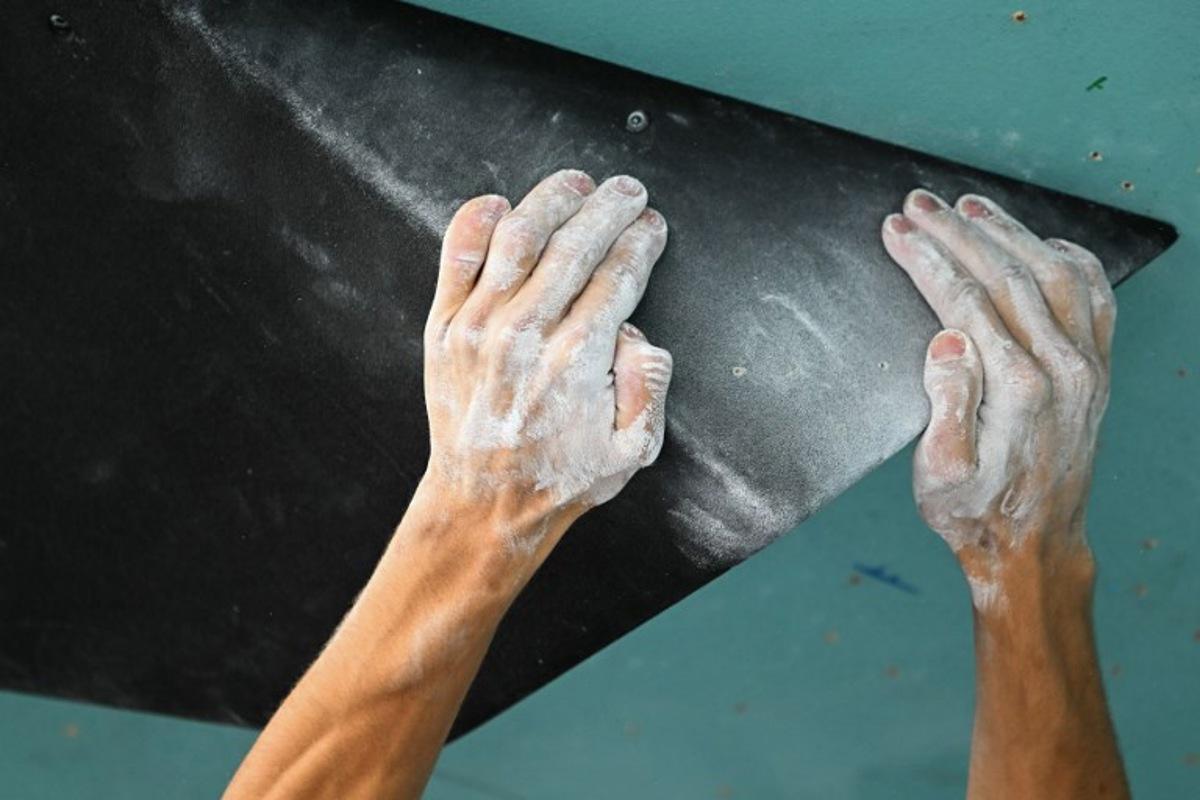 A picture shows the hands of French Paul Jenft while competing in the men's sport climbing boulder final during the Paris 2024 Olympic Games at Le Bourget Sport Climbing Venue in Le Bourget on August 9, 2024. Fabrice COFFRINI / AFP