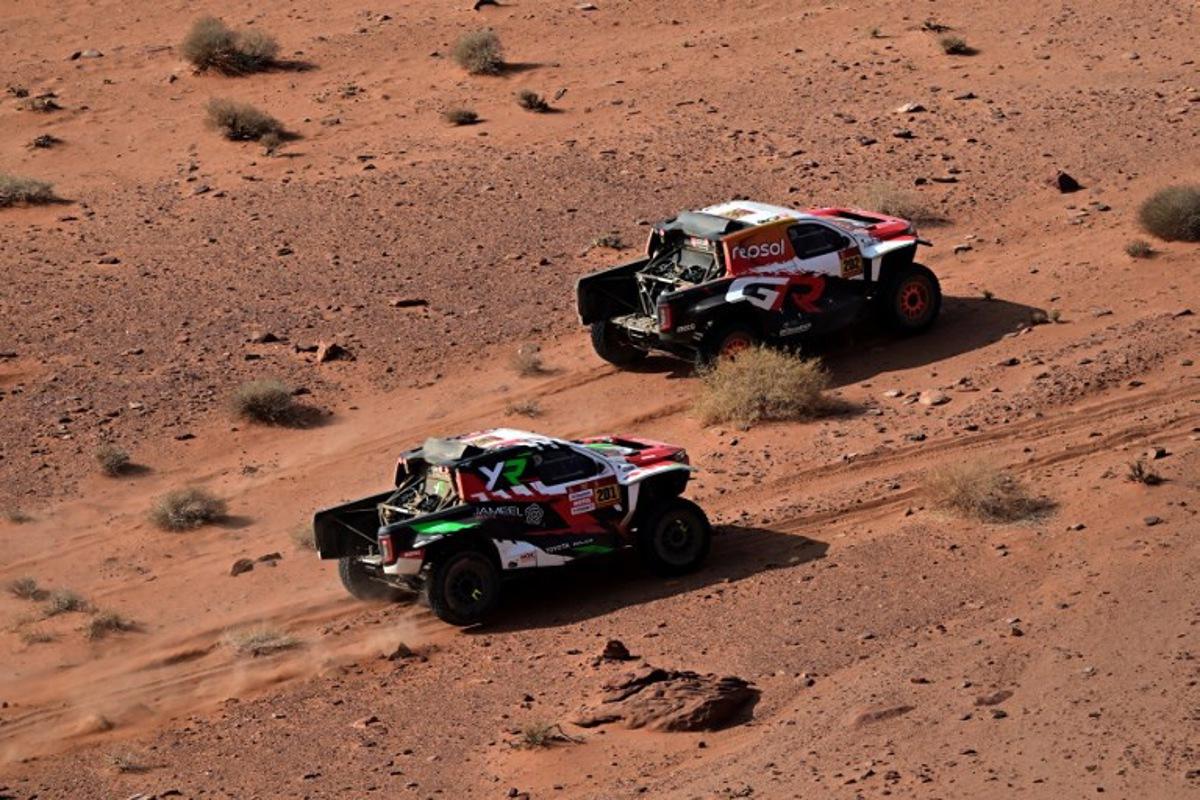 Overdrive Racing's Saudi driver Yazeed al-Rajhi and German co-driver Timo Gottschalk (left) prepare to overtake Toyota Gazoo Racing W2RC's South African driver Henk Lategan and South African co-driver Breet Cummings during the Stage 3 of the 48th edition of the Dakar Rally, between Al-Ula and Al-Ula in Saudi Arabia, on January 6, 2026. Giuseppe CACACE / AFP