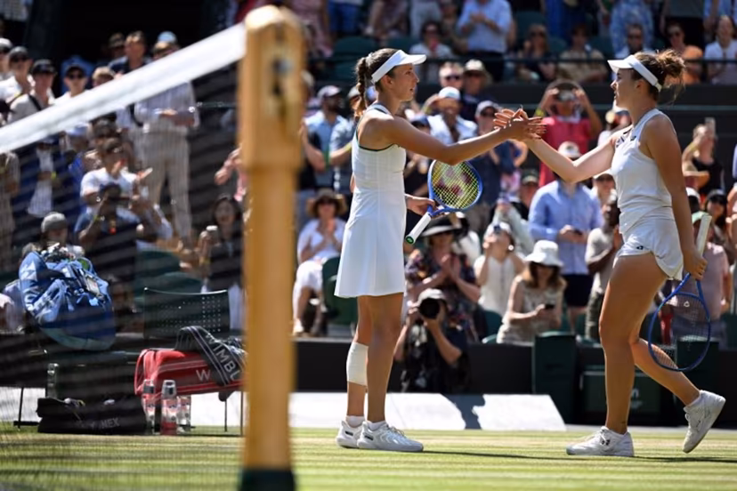 Czech Republic's Linda Noskova (R) is congratulated by Belgium's Elise Mertens for winning their women's singles quarter-final tennis match on the tenth day of the 2026 Wimbledon Championships at The All England Lawn Tennis and Croquet Club in Wimbledon, southwest London, on July 8, 2026. Kirill KUDRYAVTSEV / AFP