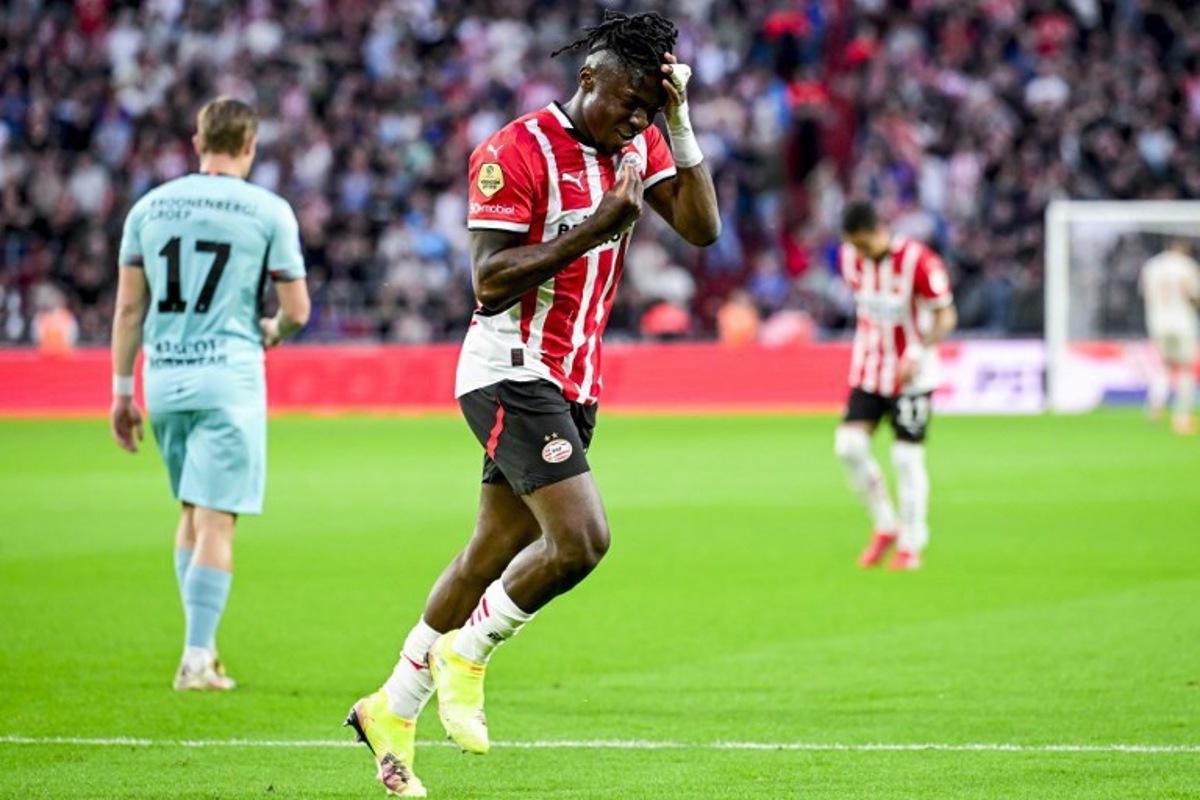 Eindhoven's Belgian forward #11 Johan Bakayoko celebrates scoring his team's second goal during the Dutch Eredivisie fooball match between PSV Eindhoven and Almere City FC at the Phillips Stadium in Eindhoven on April 12, 2025. Olaf Kraak / ANP / AFP