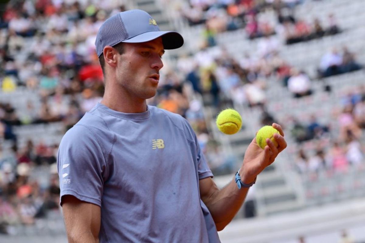USA's Tommy Paul chooses a ball before serving during the men's singles quarter-final match against Poland's Hubert Hurkacz at the ATP Rome Open tennis tournament at Foro Italico in Rome on May 15, 2025. Piero CRUCIATTI / AFP