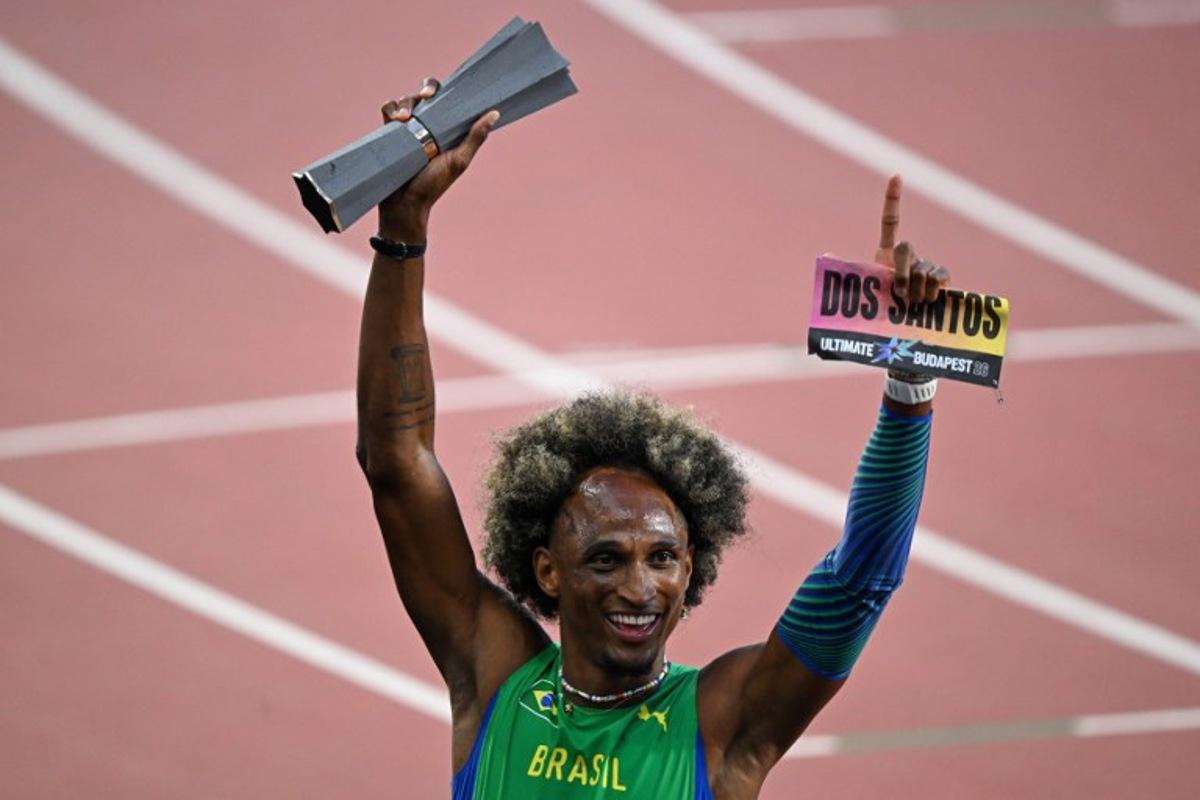 Brazil's Alison Dos Santos celebrates with his trophy after winning men's 400m hurdles final during the World Athletics Ultimate Championship at the Gyula Zsivotzky National Athletics Centre, in Budapest on September 13, 2026. Attila KISBENEDEK / AFP