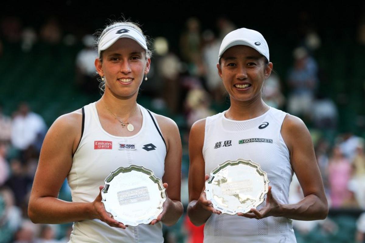 Runners-up Belgium's Elise Mertens (L) and China's Zhang Shuai pose with their trophies after being defeated during their women's doubles final tennis match against Czech Republic's Barbora Krejcikova and Katerina Siniakova on the fourteenth day of the 2022 Wimbledon Championships at The All England Tennis Club in Wimbledon, southwest London, on July 10, 2022. Adrian DENNIS / AFP