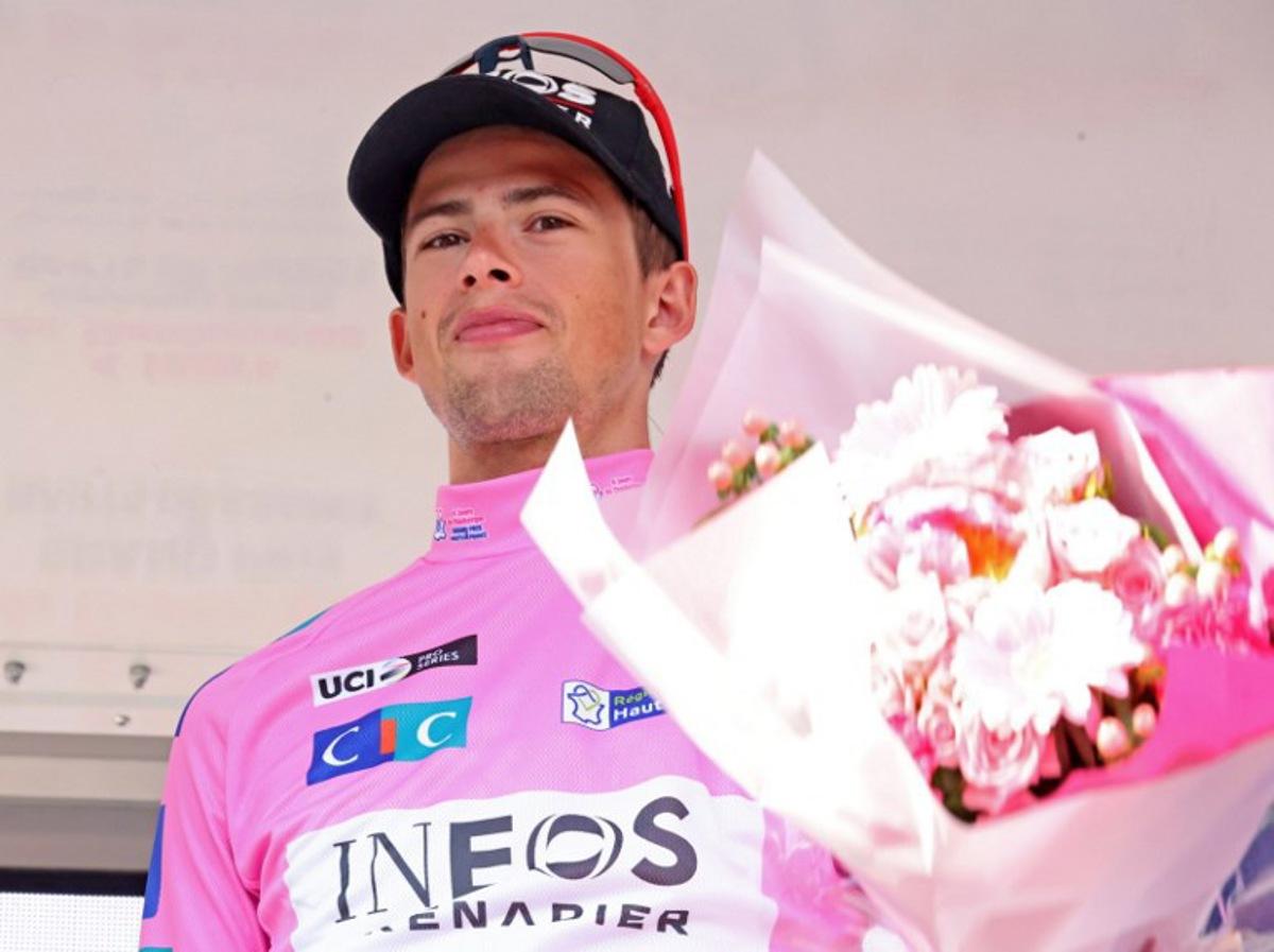 British Ineos Grenadiers cycling team's Samuel Watson poses on the podium with the winner's trophy after winning the 2025 Four Days of Dunkirk at the end of the fith and last stage, a 182,3 km bewteen Wormhout and Dunkirk, in Dunkirk on May 18, 2025. FRANCOIS LO PRESTI / AFP