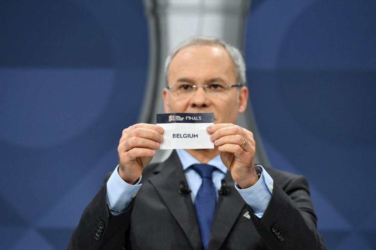 In this handout picture taken and made available by the UEFA on December 3, 2020 UEFA Deputy General Secretary Giorgio Marchetti draws out the card of Belgium during the 2021 UEFA Nations League finals draw in Nyon to decide the semi-final fixtures set to take place next October. Harold Cunningham / UEFA / AFP