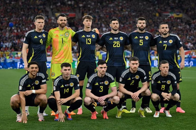 (From L) Scotland's forward #10 Che Adams, Scotland's midfielder #04 Scott McTominay, Scotland's goalkeeper #01 Angus Gunn, Scotland's midfielder #14 Billy Gilmour, Scotland's defender #13 Jack Hendry, Scotland's defender #03 Andrew Robertson, Scotland's defender #26 Scott McKenna, Scotland's defender #02 Anthony Ralston, Scotland's defender #05 Grant Hanley, Scotland's midfielder #07 John McGinn and Scotland's midfielder #08 Callum McGregor pose for photographers ahead of the UEFA Euro 2024 Group A football match between Scotland and Hungary at the Stuttgart Arena in Stuttgart on June 23, 2024. Fabrice COFFRINI / AFP