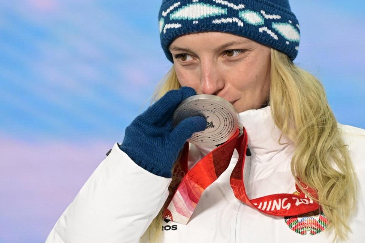 Silver medallist Belarus' Hanna Huskova kisses her medal on the podium during the freestyle skiing women's aerials victory ceremony of the Beijing 2022 Winter Olympic Games at the Zhangjiakou Medals Plaza in Zhangjiakou on February 15, 2022. Tobias SCHWARZ / AFP