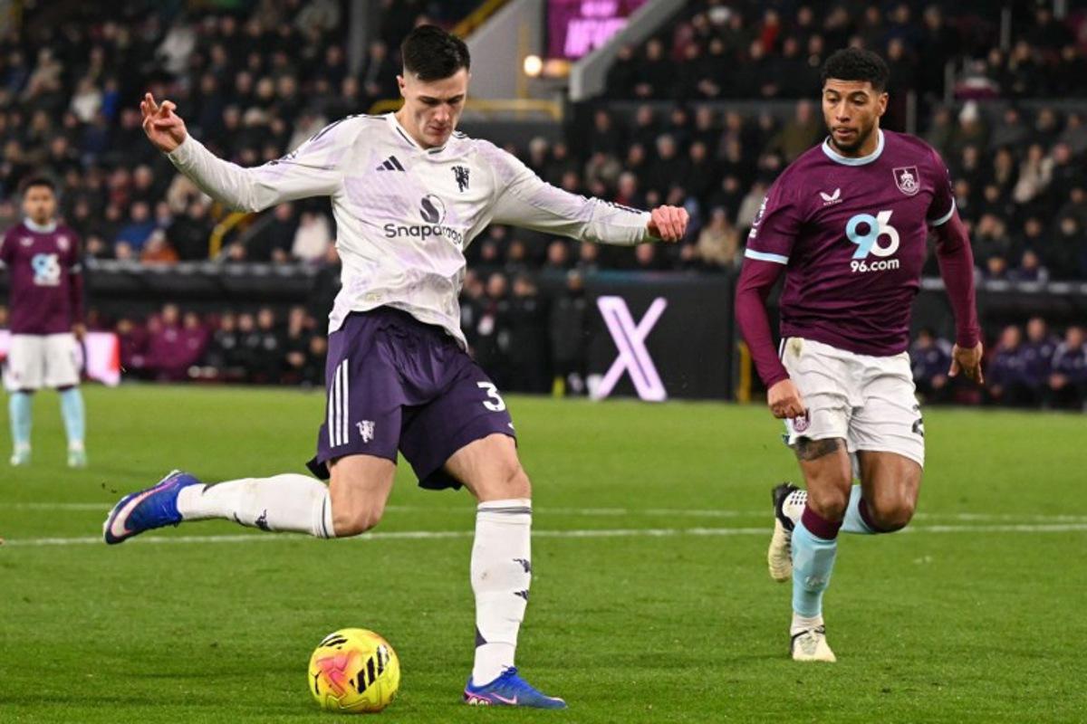 Manchester United's Slovenian striker #30 Benjamin Sesko (L) hammers the ball into the far corner to score their first goal to equalise 1-1 during the English Premier League football match between Burnley and Manchester United at Turf Moor in Burnley, north-west England on January 7, 2026. Oli SCARFF / AFP