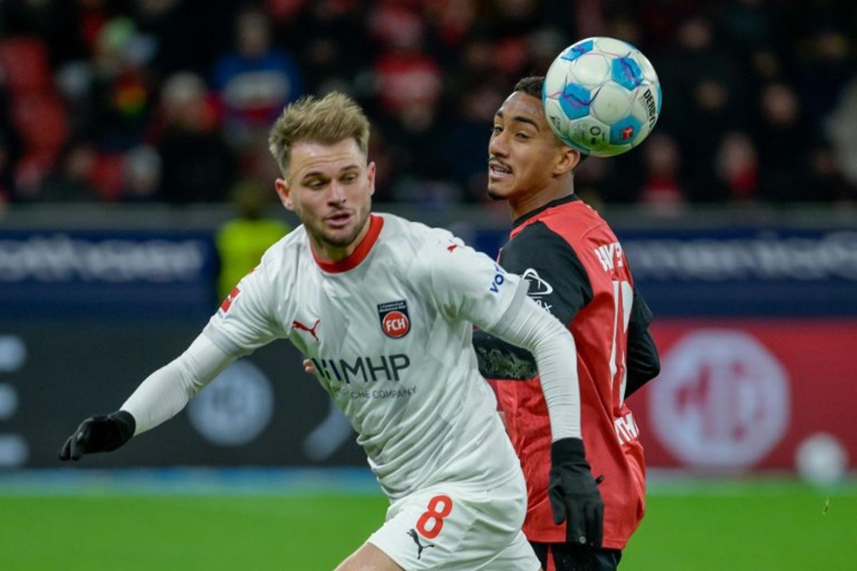 Heidenheim's Brazilian midfielder #08 Leonardo Scienza (L) and Bayer Leverkusen's Brazilian defender #13 Arthur vie for the ball during the German first division Bundesliga football match between Bayer 04 Leverkusen und 1 FC Heidenheim in Leverkusen, western Germany on November 23, 2024. SASCHA SCHUERMANN / AFP