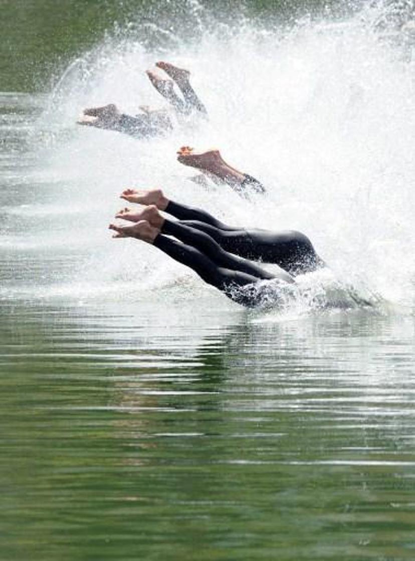 Competitors dive at the start of the men's 5 kilometer race of the World Open Water Swimming Championships at Guadalquivir river in Seville, Spain on May 6, 2008. AFP PHOTO/CRISTINA QUICLER