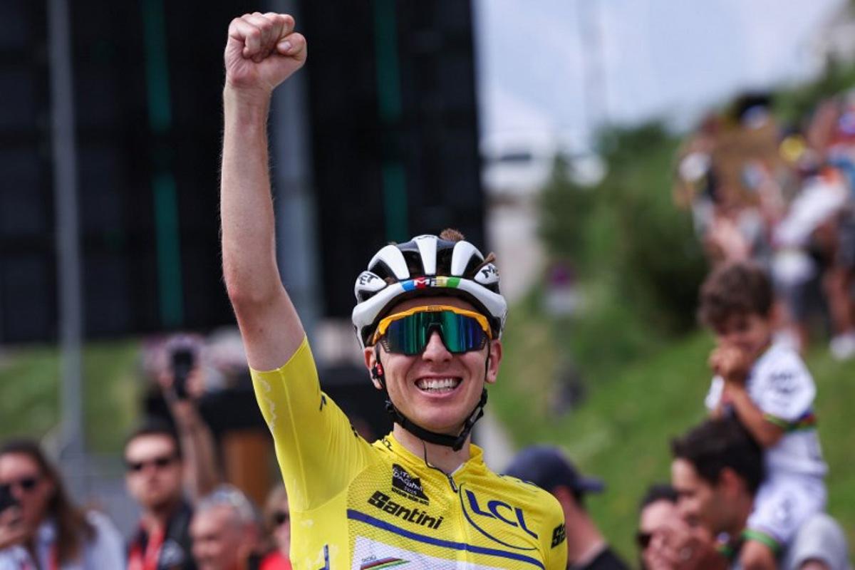 UAE Team Emirates XRG's Slovenian rider Tadej Pogačar wearing the overall leader's yellow jersey celebrates as he crosses the finish line to win the 7th stage of the 77th edition of the Criterium du Dauphine cycling race, 131,6 km between Grand-Aigueblanche and Valmeinier, on June 14, 2025. Anne-Christine POUJOULAT / AFP