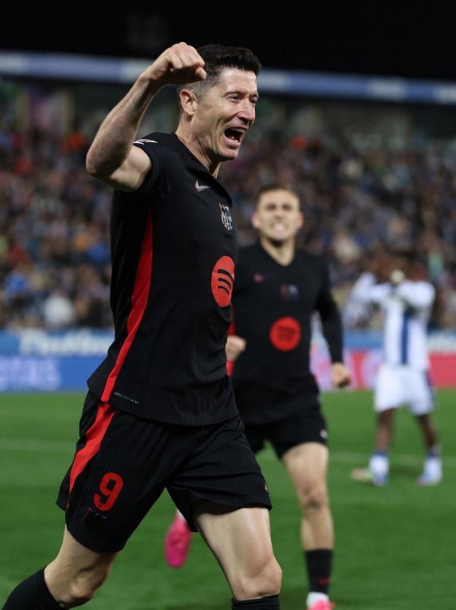 Barcelona's Polish forward #09 Robert Lewandowski celebrates after Leganes' Spanish defender #03 Jorge Saenz scored an own goal during the Spanish league football match between Club Deportivo Leganes SAD and FC Barcelona at the Estadio Municipal Butarque in Leganes, near Madrid, on April 12, 2025. Thomas COEX / AFP