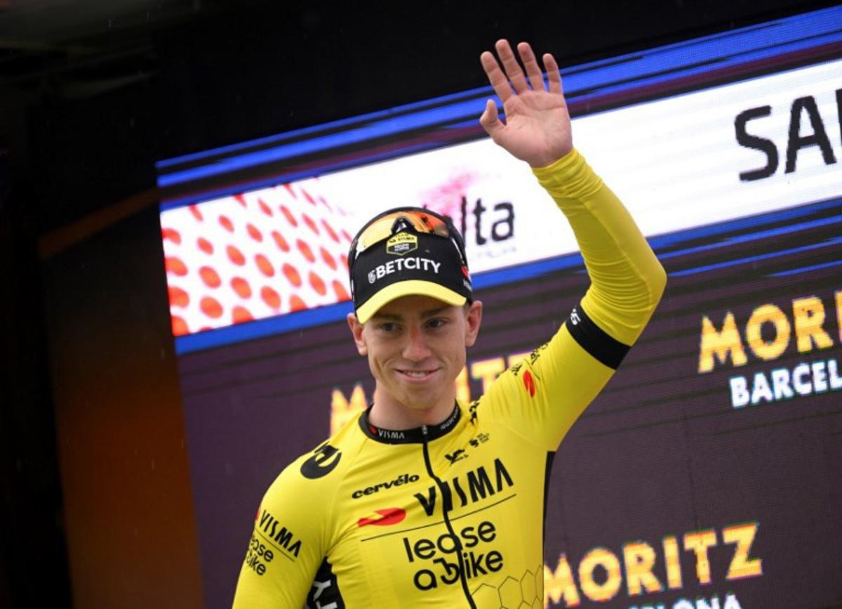 Stage winner Team Visma's British rider James Matthew Brennan celebrates with the yellow jersey on the podium of the first stage of the 2025 Volta a Catalonya cycling tour of Catalonya, a 178,3 km loop starting and finishing in Sant Feliu de Guixols, on March 24, 2025. Josep LAGO / AFP