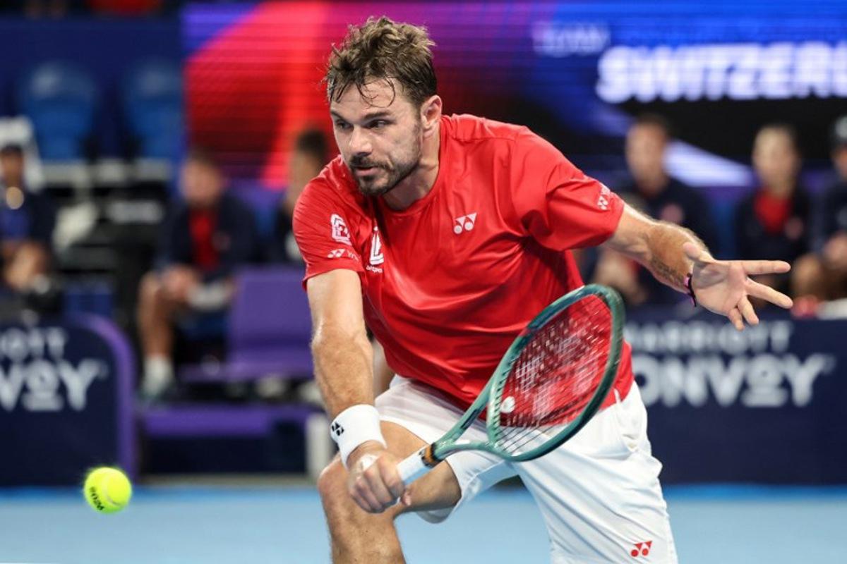 Switzerland's Stan Wawrinka hits a return to Argentina's Sebastian Baez during their men's singles match at the United Cup tennis tournament in Perth on January 7, 2026. Antony DICKSON / AFP
