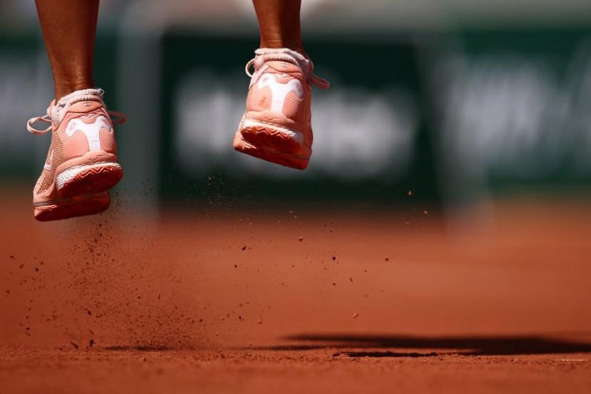 Clay falls from the sneakers of jumping Poland's Magda Linette as she plays against Canada's Leylah Fernandez during their women's singles match on day one of the Roland-Garros Open tennis tournament at the Court Simonne-Mathieu in Paris on May 28, 2023. Anne-Christine POUJOULAT / AFP