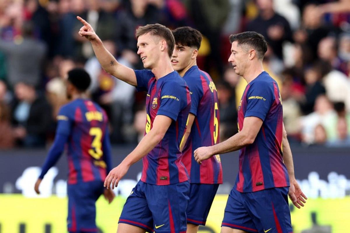 Barcelona's Spanish midfielder #20 Daniel Olmo (L) celebrates scoring his team's second goal during the Spanish League football match between FC Barcelona and Deportivo Alaves at Camp Nou Stadium in Barcelona on November 29, 2025. Josep LAGO / AFP