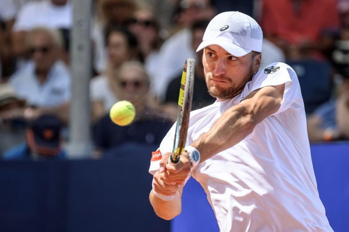 Belgium's Raphael Collignon returns the ball to Greece's Stefanos Tsitsipas during their men's singles final match at the Swiss Open tennis tournament in Gstaad, on July 19, 2026. Fabrice COFFRINI / AFP