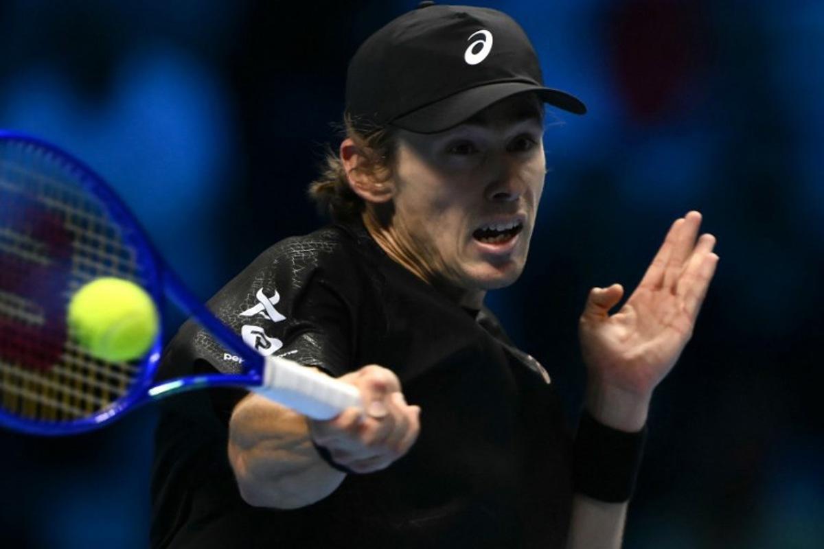 Australia's Alex De Minaur hits the ball during his match against Italy's Lorenzo Musetti at the ATP Finals tennis tournament in Turin on November 11, 2025. Marco BERTORELLO / AFP