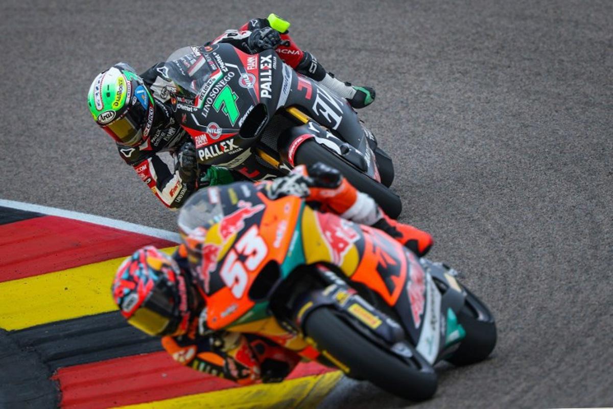 Fantic Racing Team's Belgiums Moto2 rider Barry Baltus (background) steers his bike behind Red Bull KTM Ajo Team's Turkish Moto2 rider Deniz Oncu (front) during the German Moto2 Grand Prix at the Sachsenring racing circuit, in Hohenstein-Ernstthal near Chemnitz, eastern Germany on July 13, 2025. Ronny Hartmann / AFP