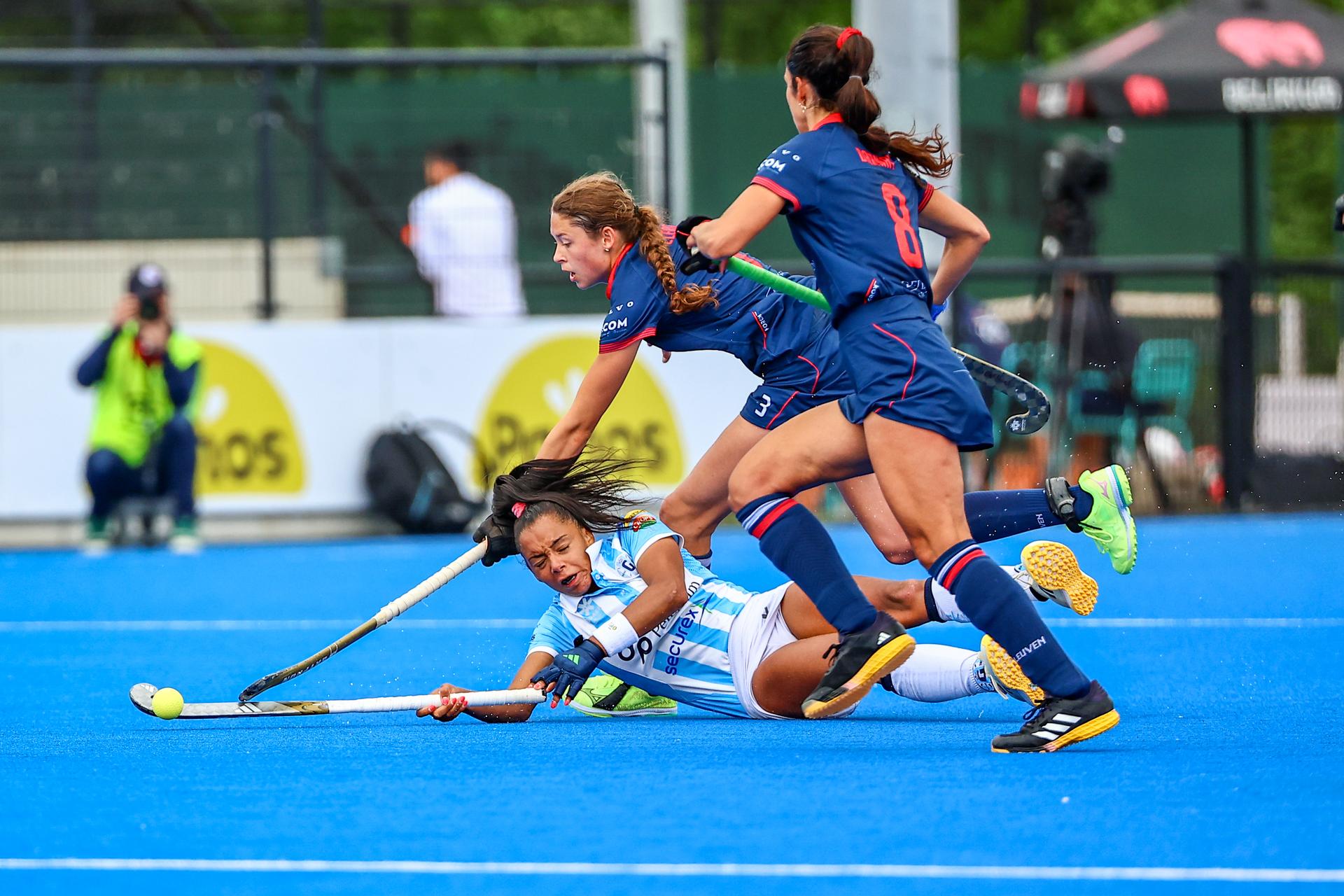 Gantoise's Ambre Ballenghien fight for the ball during a hockey game between Gantoise and Leuven, Sunday 18 May 2025 in Gent, in the semi-finals of the playoffs in the Belgian Hockey League women during the 2024-2025 season. BELGA PHOTO DAVID PINTENS
