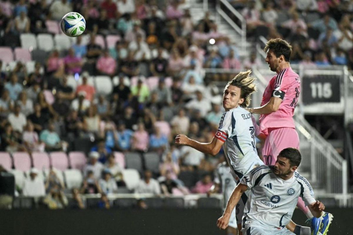 Inter Miami's Argentine forward #10 Lionel Messi (R) heads the ball over Chicago's English defender #03 Jack Elliott and Belgian forward #09 Hugo Cuypers during the Major League Soccer (MLS) regular season football match between Inter Miami CF and Chicago Fire FC at Chase Stadium in Fort Lauderdale, Florida, on September 30, 2025. CHANDAN KHANNA / AFP