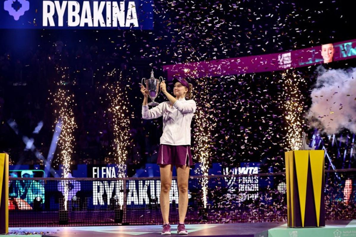 Kazakhstan's Elena Rybakina lifts the trophy after defeating Belarus' Aryna Sabalenka in the final of the Women's WTA Finals, in Riyadh on November 8, 2025. Rybakina beat world number one Aryna Sabalenka 6-3, 7-6 (7/0) to win the WTA Finals for the first time in Riyadh on November 8, to earn a record $5.235 million. Fayez NURELDINE / AFP