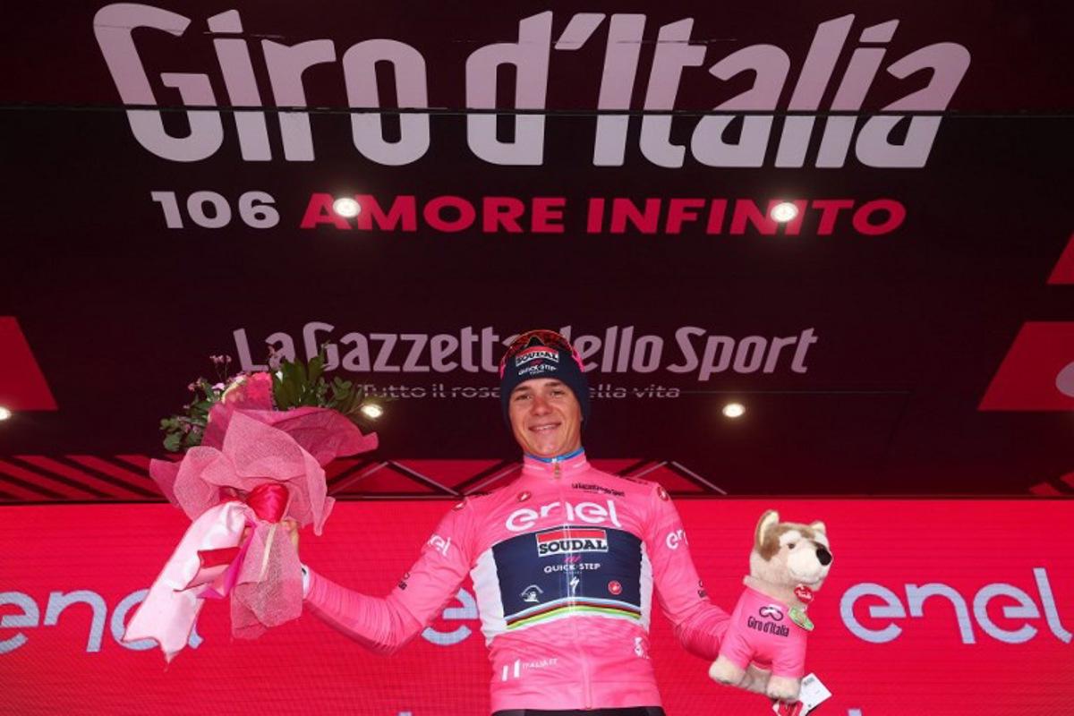 Soudal - Quick Step's Belgian rider Remco Evenepoel celebrates his overall leader's pink jersey on the podium after winning the ninth stage of the Giro d'Italia 2023 cycling race, a 35 km individual time trial between Savignano sul Rubicone and Cesena, on May 14, 2023. Luca Bettini / AFP