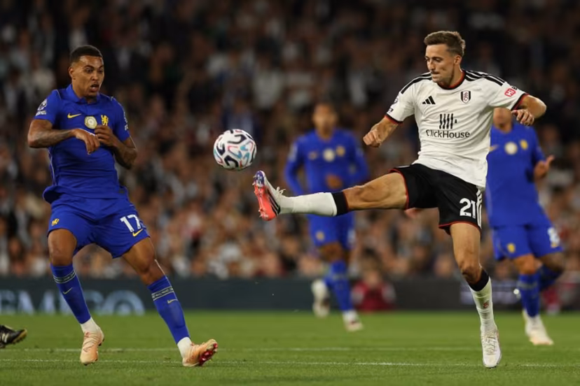 Fulham's Belgian defender #21 Timothy Castagne (R) vies with Chelsea's English midfielder #17 Morgan Rogers (L) during the English Premier League football match between Fulham and Chelsea at Craven Cottage in London on August 24, 2026. Adrian Dennis / AFP