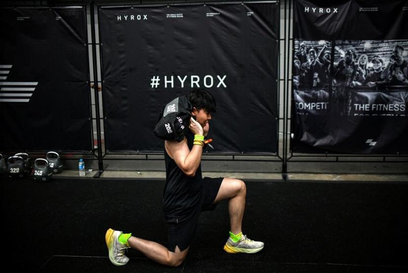 A participant warms up before competing in the Hyrox fitness race at the Bangkok International Trade and Exhibition Centre (BITEC) in Bangkok on March 21, 2026. Amaury PAUL / AFP