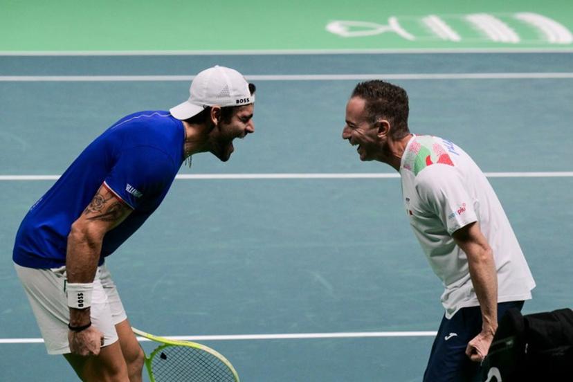 Italy's Matteo Berrettini (L) celebrates with Italy's coach Filippo Volandri after winning against Austria's Jurij Rodionov during their Davis Cup men's singles quarter finals tennis match, at the Super Tennis Arena, in Bologna, northen Italy, on November 19, 2025. Tiziana FABI / AFP