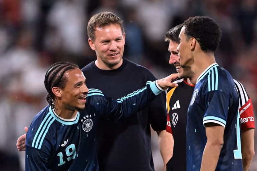 Germany's head coach Julian Nagelsmann (2L) celebrates with assistant coach Benjamin Glueck (2R) and Germany's midfielder #10 Jamal Musiala (R) and Germany's midfielder #19 Leroy Sane after their team won the friendly match between Germany and Finland ahead of the 2026 FIFA World Cup football tournament, in Mainz, western Germany on May 31, 2026. Germany won the match 4-0. Kirill KUDRYAVTSEV / AFP