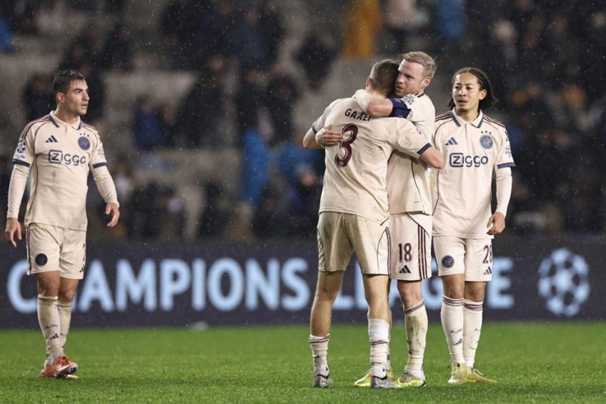Ajax's players celebrate after the UEFA Champions League league phase football match between Qarabag and Ajax at the Tofiq Bahramov Republican Stadium in Baku on December 10, 2025. Giorgi ARJEVANIDZE / AFP
