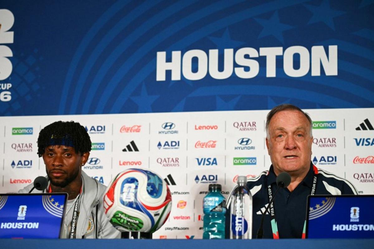 Curacao's Dutch head coach Dick Advocaat (R) gives a press conference next to Curacao's midfielder #10 Leandro Bacuna on the eve of Curacao's 2026 World Cup football tournament Group E football match against Germany in Houston on June 13, 2026. Ronaldo SCHEMIDT / AFP