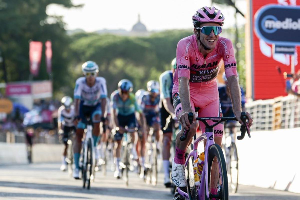 Team Visma-Lease a Bike's British rider Simon Yates wearing the pink jersey of overall leader (Maglia Rosa) celebrates as he crosses the finish line of the 21st and last stage to win the 108th Giro d'Italia cycling race of 143kms from Rome to Rome on June 1, 2025. Luca Bettini / AFP