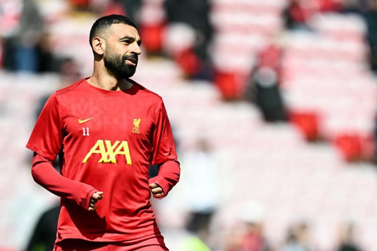 Liverpool's Egyptian striker #11 Mohamed Salah reacts as he warms up prior to the English Premier League football match between Liverpool and West Ham United at Anfield in Liverpool, north west England on April 13, 2025. Paul ELLIS / AFP
