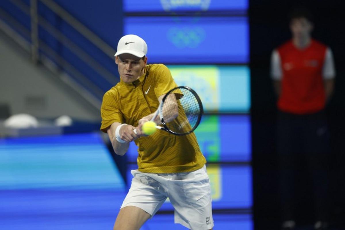 Italy's Jannik Sinner hits a return against Czech Republic's Jakub Mensik during their men's singles quarterfinal match at the Qatar Open tennis tournament in Doha on February 19, 2026. Karim JAAFAR / AFP