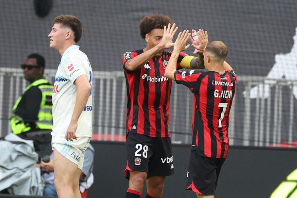Nice's French forward #07 Gauthier Hein (R) celebrates with Nice's Belgian midfielder #28 Axel Witsel (L) after scoring a goal during the French L1 football match between OGC Nice and RC Strasbourg Alsace at the Allianz Riviera Stadium in Nice on October 11, 2026. Valery HACHE / AFP