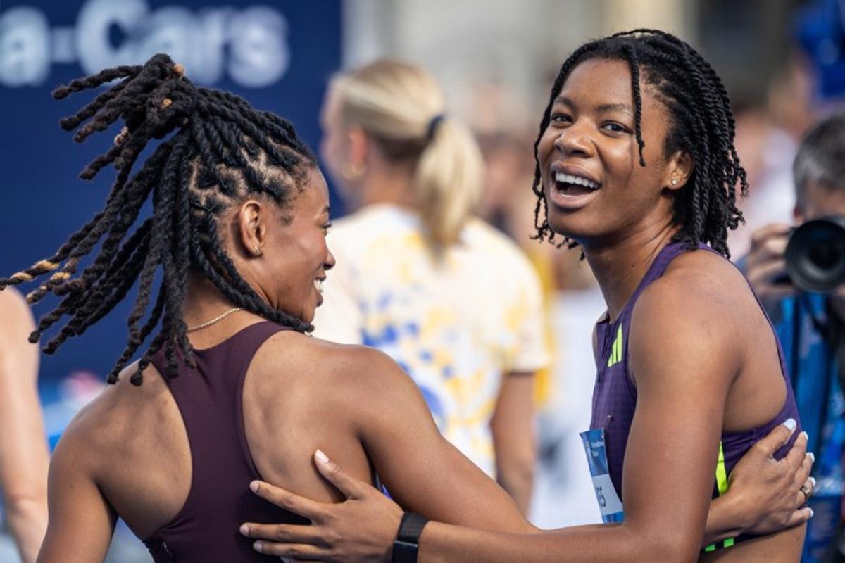 First placed USA's Alyssa Jones (R) and her compatriot, third placed Monae' Nichols celebrate after the women's long jump event of the Silesia Diamond League athletics meeting in Katowice, Poland, on August 22, 2026. Wojtek RADWANSKI / AFP
