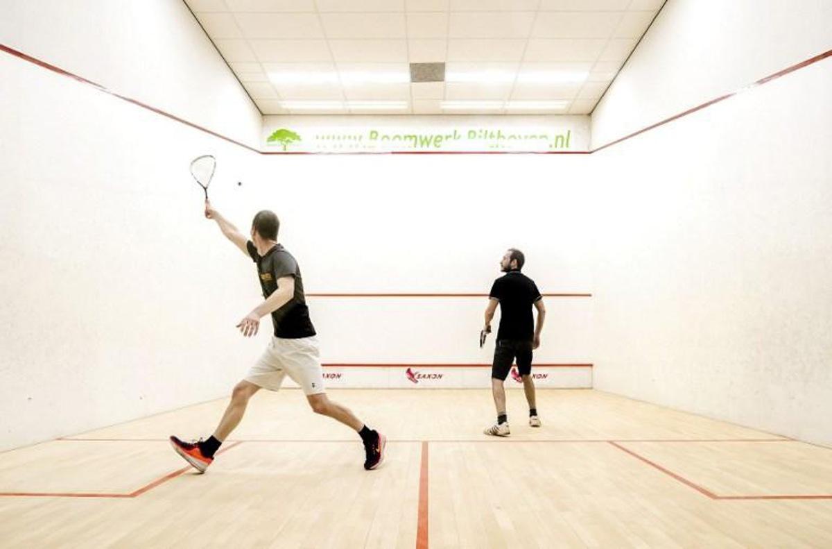 Visitors hit their ball at Squash Utrecht in Utrecht, on April 10, 2021. The accommodation is the very first indoor sports location that is allowed to reopen after the lockdown ; a negative Covid-19 test certificate is required to enter. Remko de Waal / ANP / AFP Netherlands OUT
