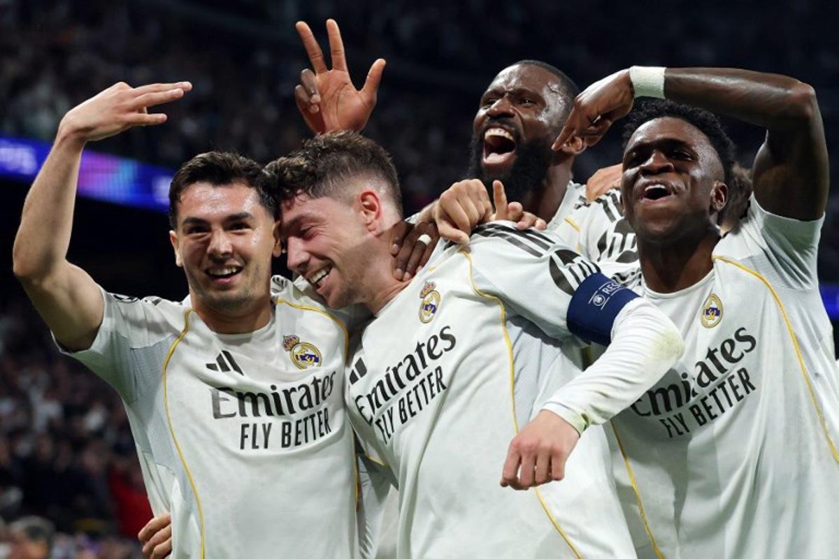 Real Madrid's Uruguayan midfielder #08 Federico Valverde (2L) celebrates his third goal during the UEFA Champions League last 16 first leg football match between Real Madrid CF and Manchester City at Santiago Bernabeu Stadium in Madrid on March 11, 2026. Pierre-Philippe MARCOU / AFP