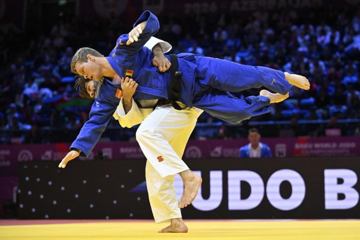 Azerbaijan's Zelim Tckaev (white) competes against Belgium's Matthias Casse in the men's under 81 kg quarter-final at the World Judo Championships in Baku on October 7, 2026. Alexander NEMENOV / AFP