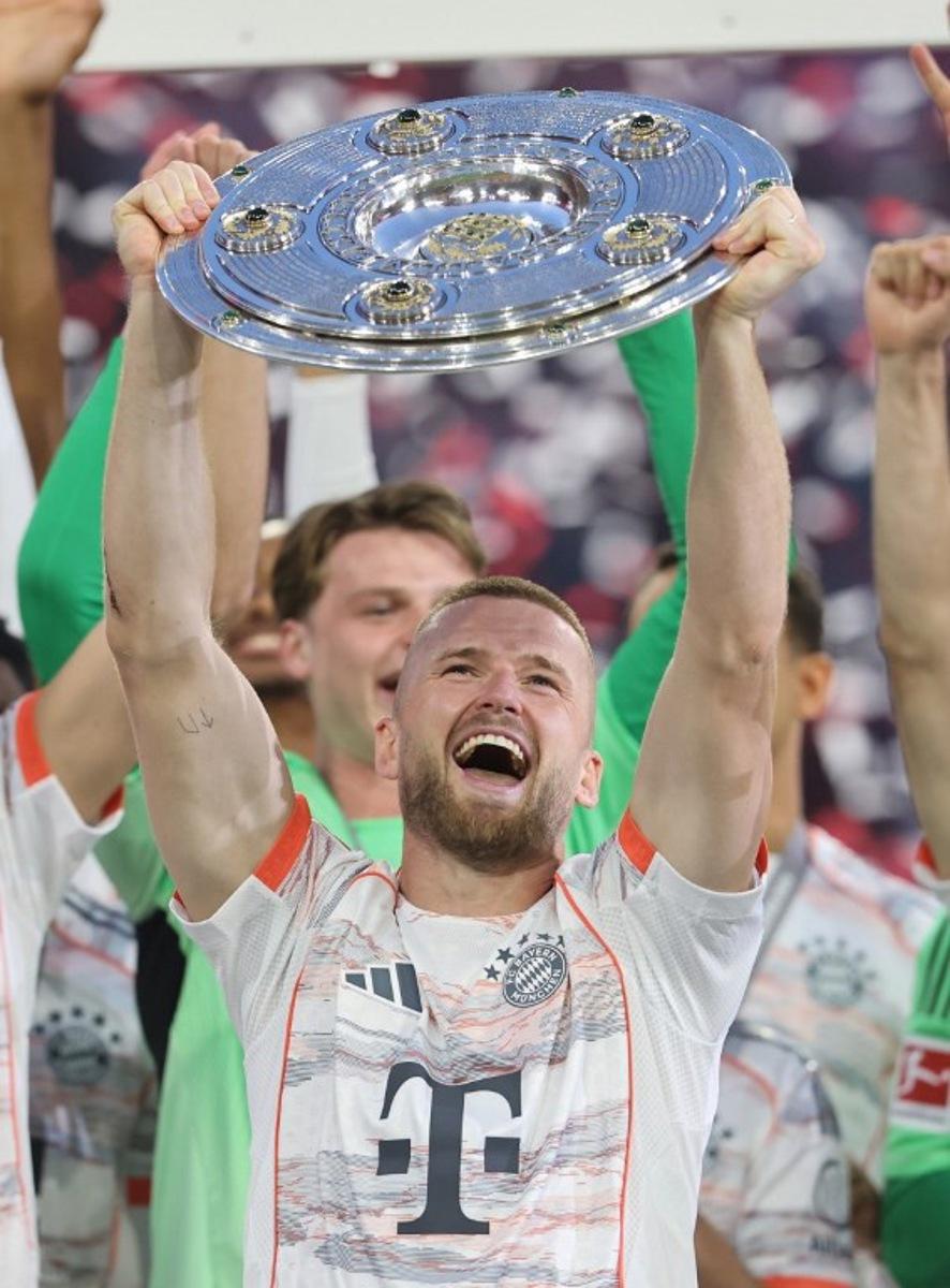 Bayern Munich's English defender #15 Eric Dier lifts the trophy after the German first division Bundesliga football match between Bayern Munich and Borussia Moenchengladbach in Munich on May 10, 2025. Alexandra BEIER / AFP