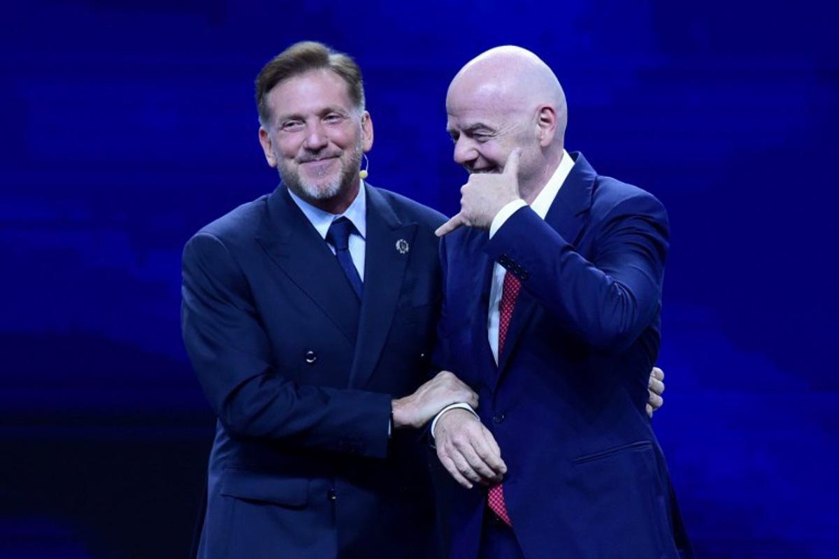 FIFA President Gianni Infantino (R) gestures next to CONMEBOL President Alejandro Dominguez (L) during a commemorative event marking the 10th anniversary of Dominguez's work as the head of the South American Football Confederation in Luque, Paraguay on January 26, 2026. Daniel DUARTE / AFP