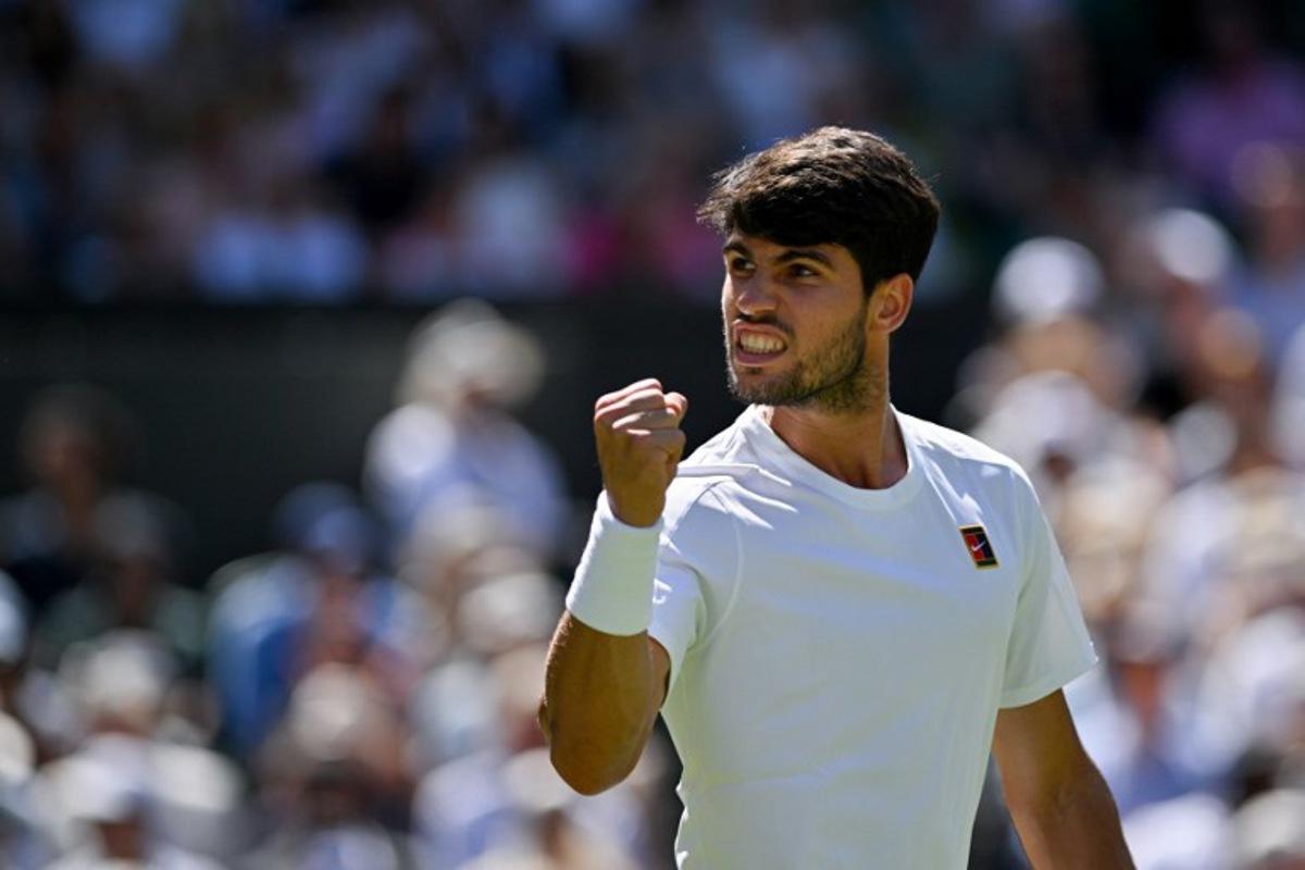 Spain's Carlos Alcaraz celebrates winning the first set against US player Taylor Fritz during their men's singles semi-final tennis match on the twelfth day of the 2025 Wimbledon Championships at The All England Lawn Tennis and Croquet Club in Wimbledon, southwest London, on July 11, 2025. Glyn KIRK / AFP