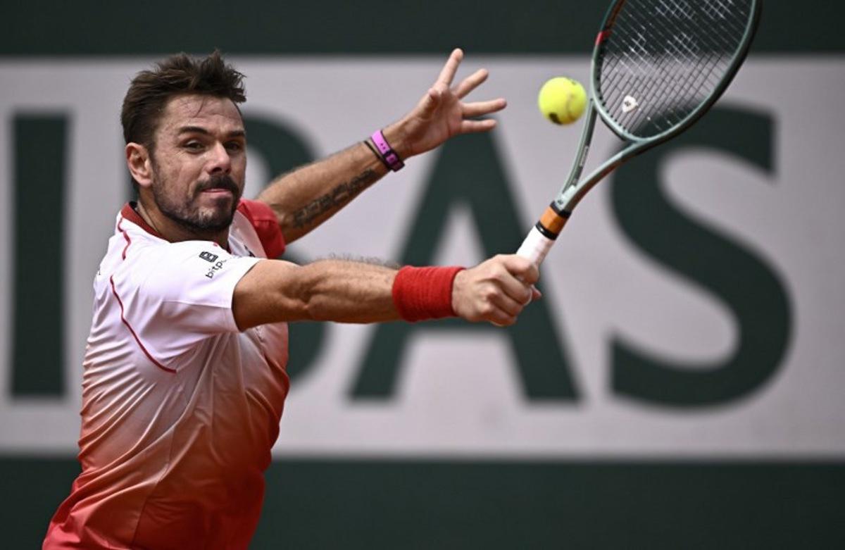Switzerland's Stan Wawrinka plays a backhand return to Great Britain's Jacob Fearnley during their men's singles match on day 2 of the French Open tennis tournament at the Roland-Garros Complex in Paris on May 26, 2025. JULIEN DE ROSA / AFP