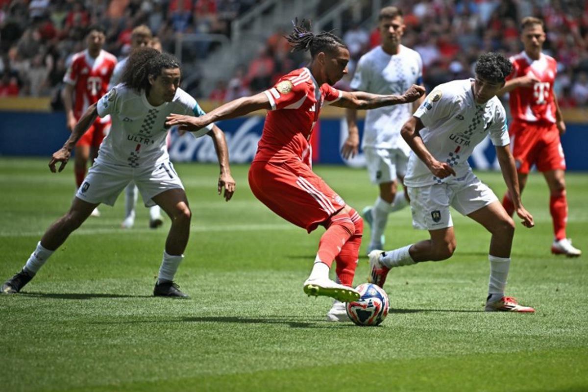 Bayern Munich's French midfielder #17 Michael Olise (C) fights for the ball with Auckland City's New Zealander midfielder #10 Dylan Manickum (L) and Auckland City's New Zealander defender #13 Nathan Lobo during the Club World Cup 2025 Group C football match between Germany's Bayern Munich and New Zealand's Auckland City at the TQL stadium in Cincinnati on June 15, 2025. Paul ELLIS / AFP